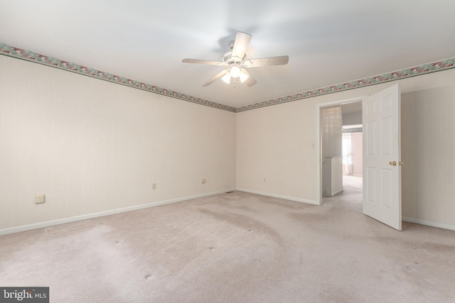 empty room with light carpet, baseboards, and ceiling fan