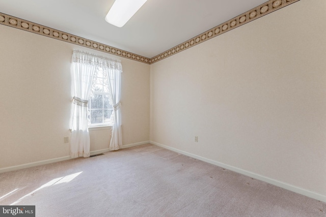 unfurnished room featuring baseboards, carpet floors, and visible vents