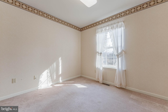 empty room with visible vents, baseboards, and carpet flooring