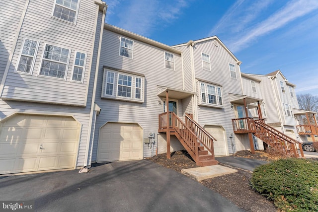 view of front of home featuring a residential view, a garage, and driveway