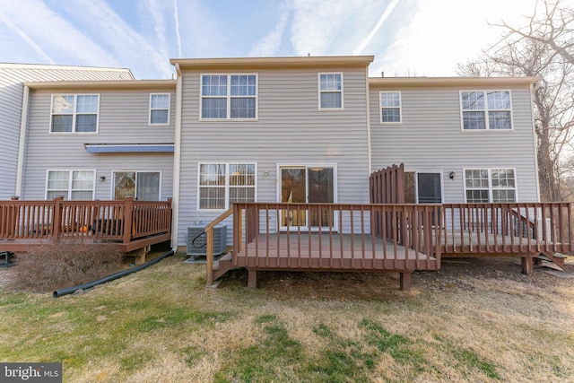 rear view of property featuring a yard, central AC, and a wooden deck