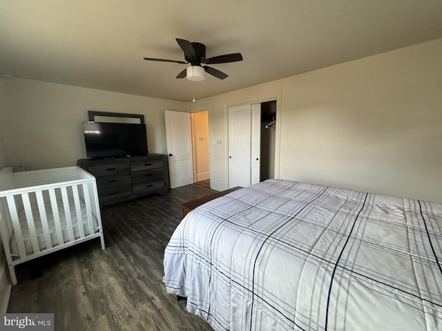 bedroom with ceiling fan, dark wood finished floors, and a closet