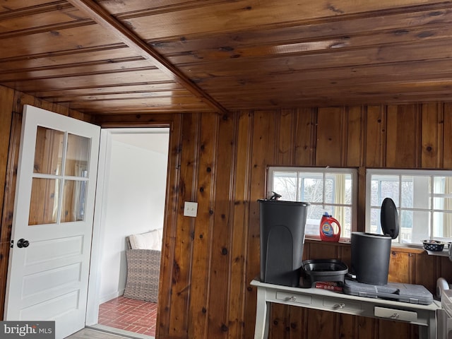 interior space with brick floor, wood walls, and wooden ceiling