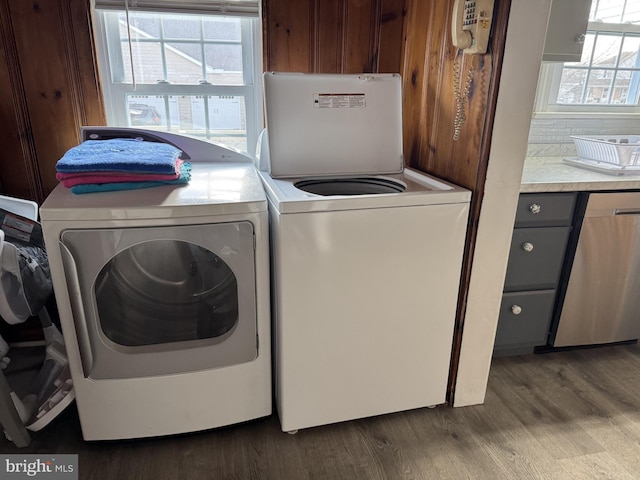 laundry area with dark wood-style floors, laundry area, and washing machine and dryer