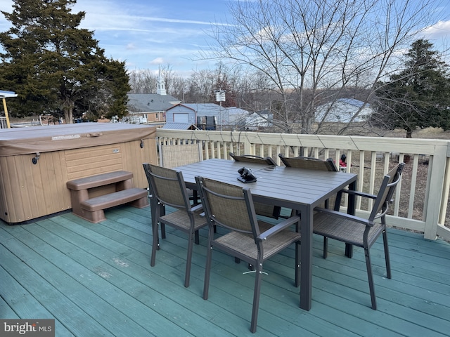 wooden terrace featuring a hot tub and outdoor dining area