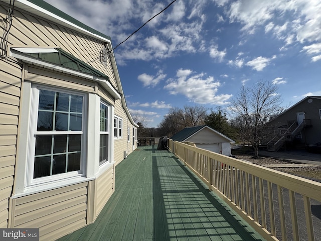 wooden terrace featuring an outbuilding