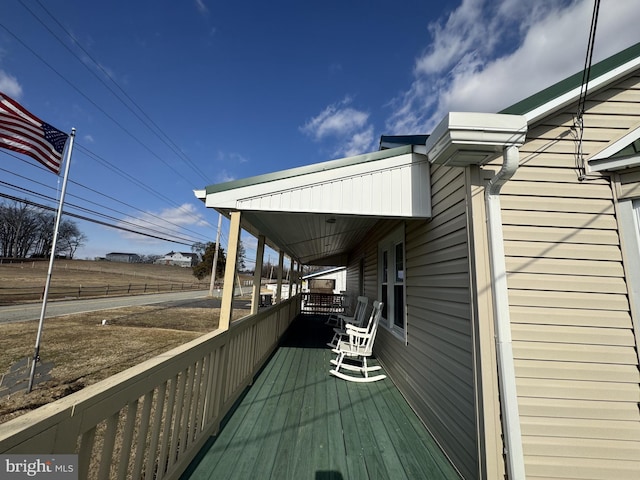 wooden terrace featuring covered porch