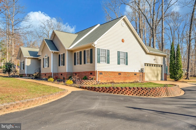 view of side of home featuring driveway and an attached garage