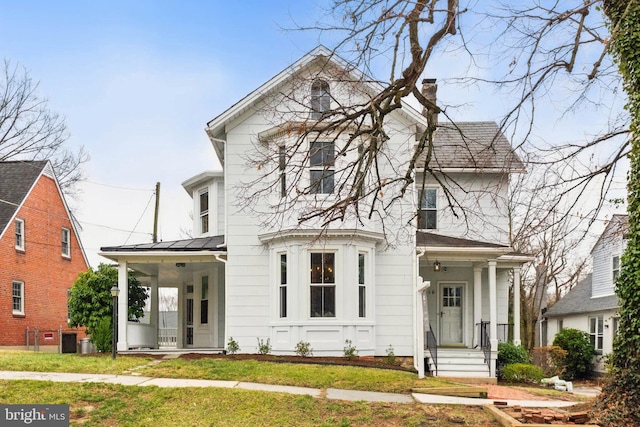 view of front of house featuring a chimney and a front lawn