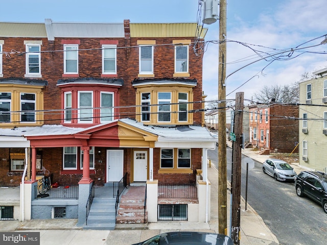 townhome / multi-family property featuring brick siding