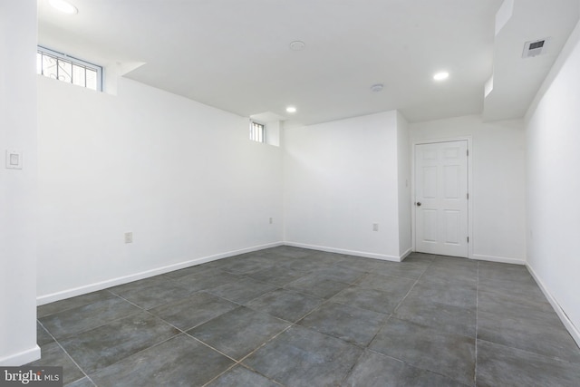 basement with baseboards, visible vents, and recessed lighting