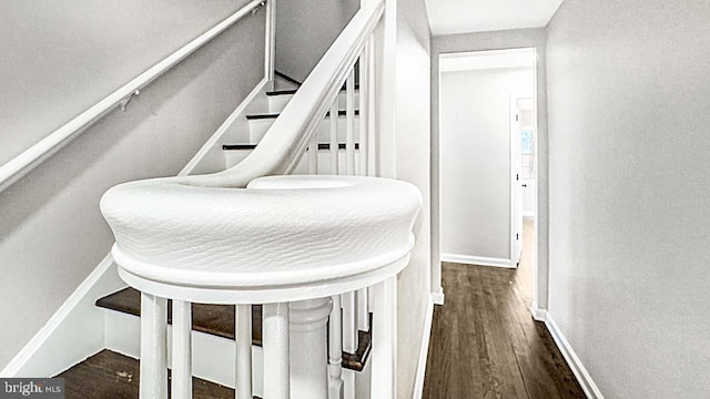 hallway featuring wood finished floors and baseboards