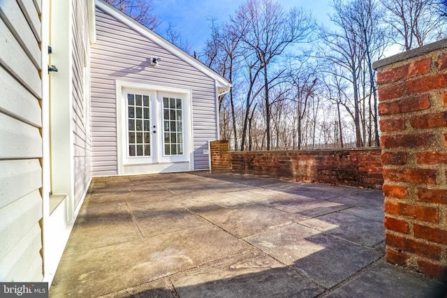 view of patio with french doors and fence