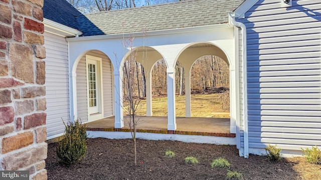 view of property exterior with a shingled roof