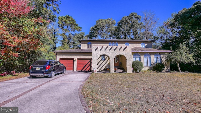 view of front facade with driveway, an attached garage, and stucco siding