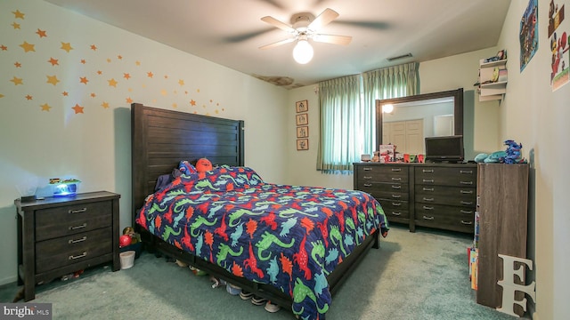 bedroom with a ceiling fan, visible vents, and light colored carpet