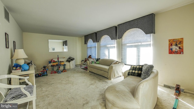 living area featuring light carpet and visible vents