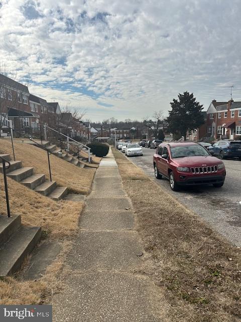 view of road with sidewalks and a residential view