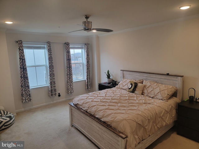 bedroom with light carpet, ceiling fan, baseboards, and crown molding