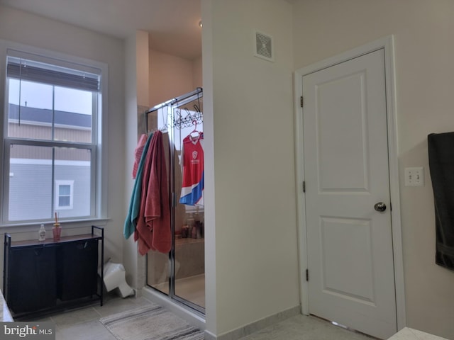 bathroom featuring visible vents, baseboards, and tile patterned floors