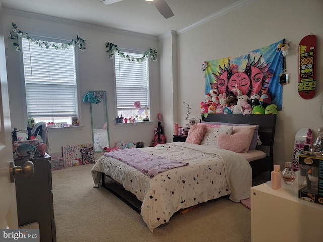 carpeted bedroom with a ceiling fan and crown molding