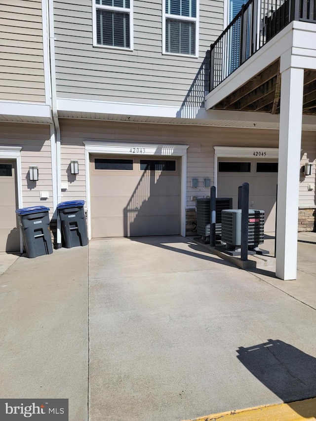 exterior space featuring central AC unit and concrete driveway