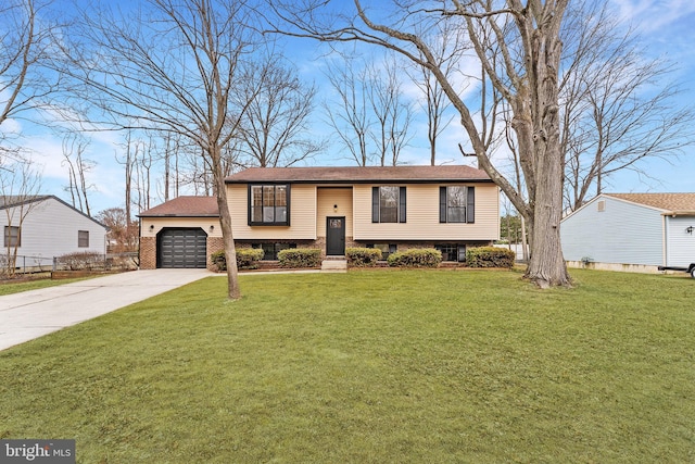 raised ranch featuring concrete driveway, an attached garage, brick siding, and a front lawn