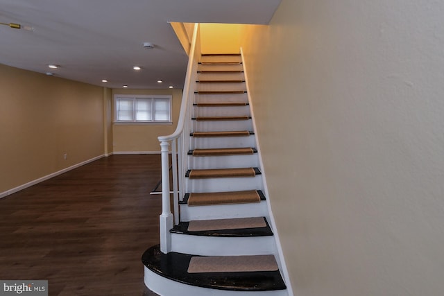 staircase with recessed lighting, wood finished floors, and baseboards