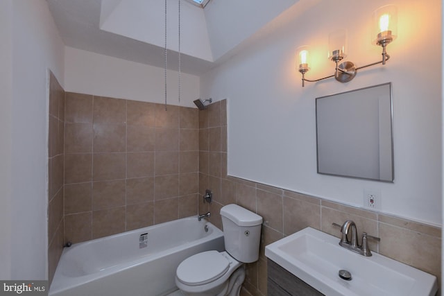 full bathroom featuring toilet, shower / tub combination, tile walls, and vanity