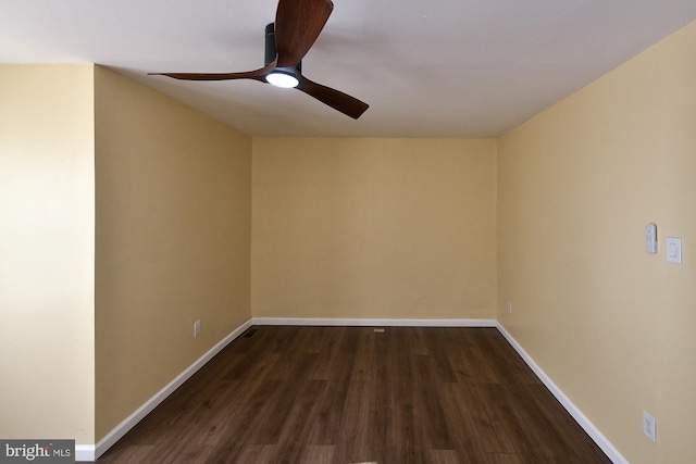 spare room featuring ceiling fan, baseboards, and dark wood finished floors