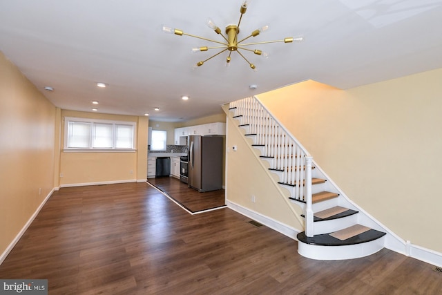 unfurnished living room featuring dark wood-style floors, stairs, baseboards, and recessed lighting