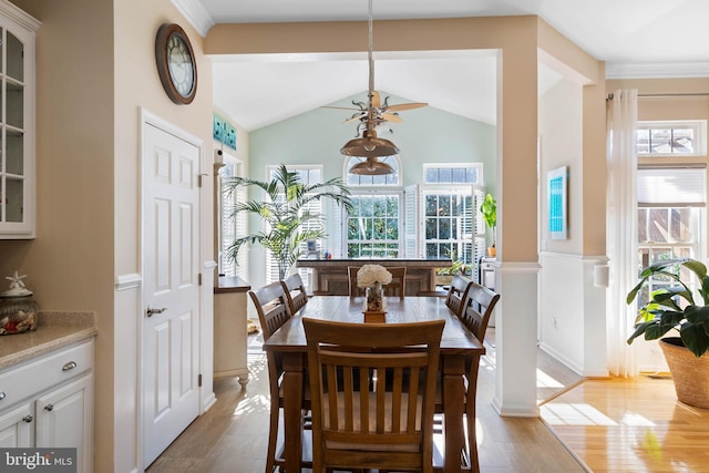 dining space featuring lofted ceiling and light wood-style flooring