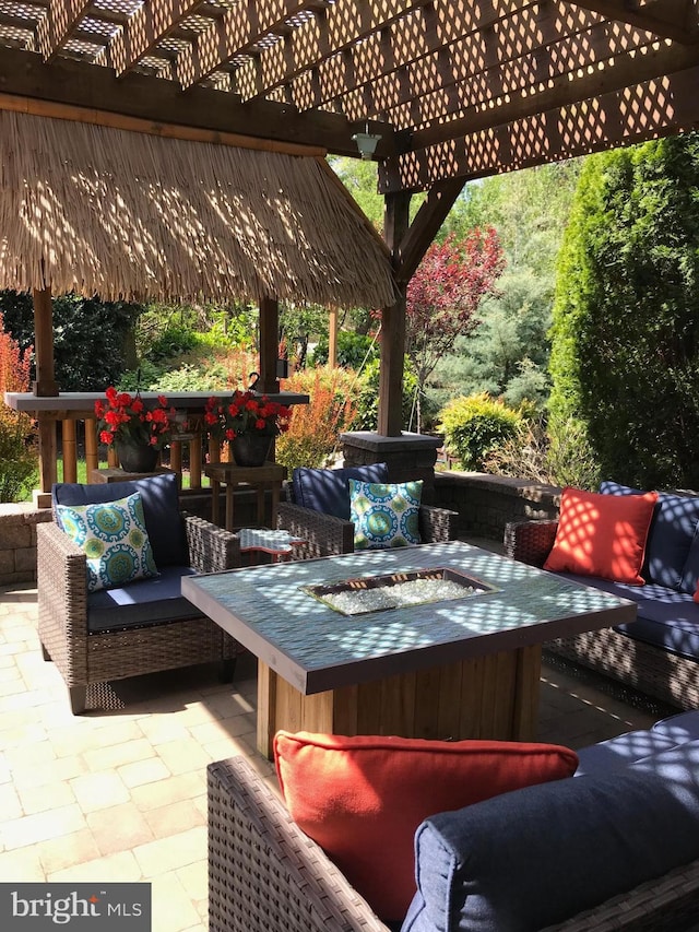 view of patio / terrace featuring an outdoor living space with a fire pit and a pergola