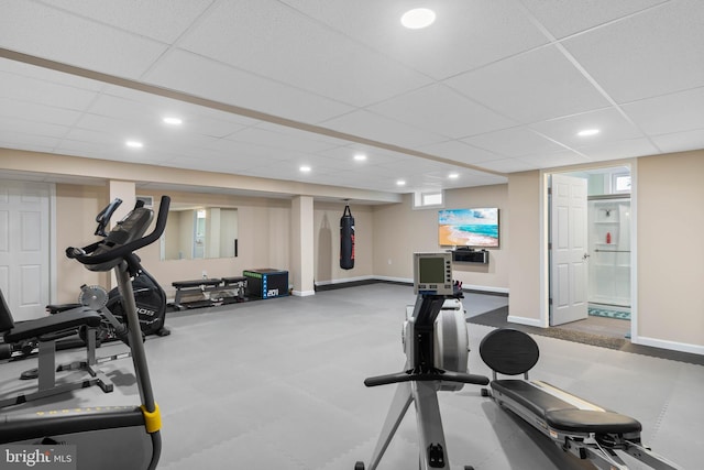 exercise area with recessed lighting, a drop ceiling, and baseboards