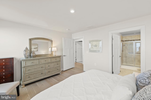 bedroom featuring light wood-type flooring, connected bathroom, and recessed lighting