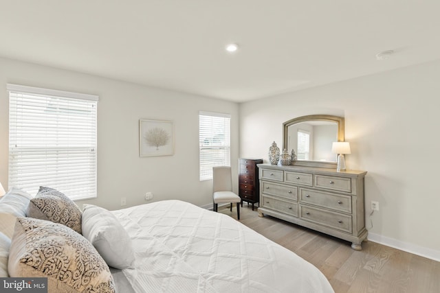 bedroom featuring recessed lighting, light wood-type flooring, and baseboards