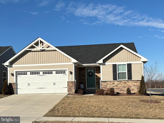 craftsman-style home featuring a shingled roof, board and batten siding, a garage, stone siding, and driveway