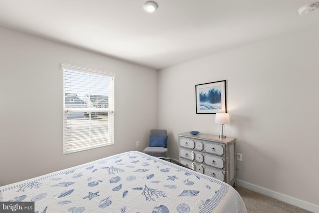 bedroom featuring carpet and baseboards