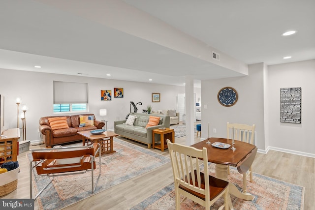 dining space featuring light wood-type flooring, visible vents, baseboards, and recessed lighting