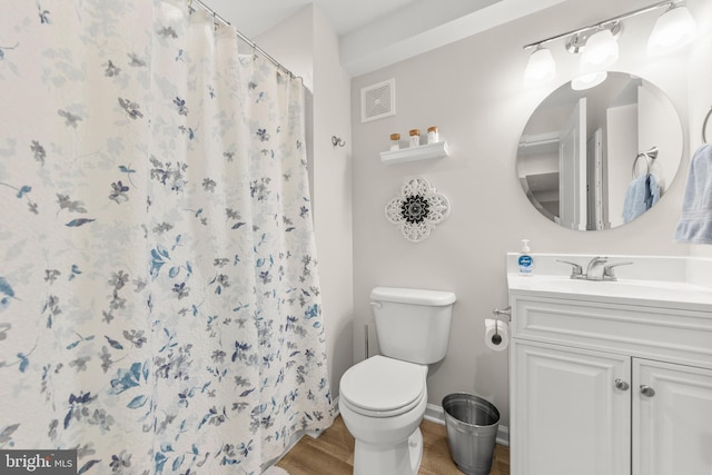 full bathroom featuring toilet, wood finished floors, visible vents, vanity, and baseboards