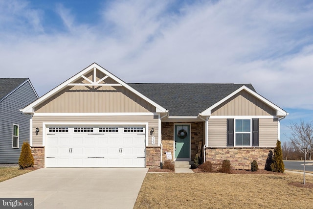 craftsman-style house with a garage, concrete driveway, a front lawn, and board and batten siding