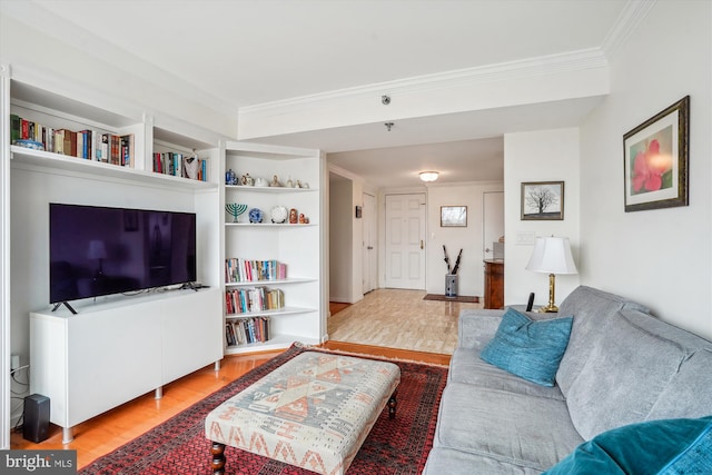 living area featuring wood finished floors and crown molding