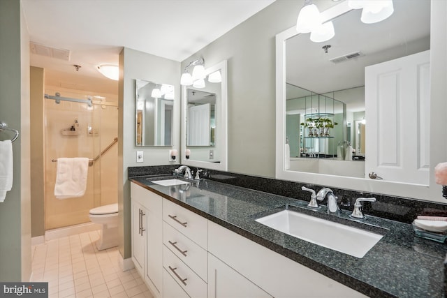 bathroom featuring a stall shower, visible vents, a sink, and tile patterned floors