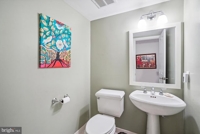 bathroom with toilet and visible vents