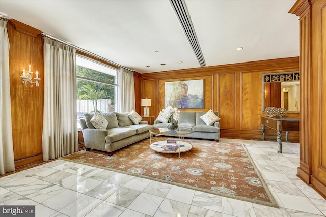 unfurnished living room with marble finish floor and wooden walls