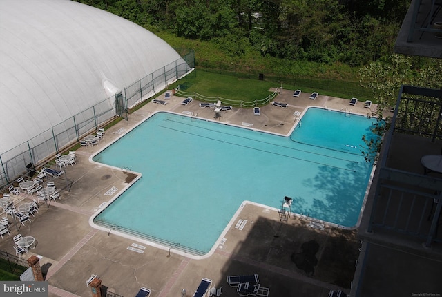 pool featuring a patio and fence