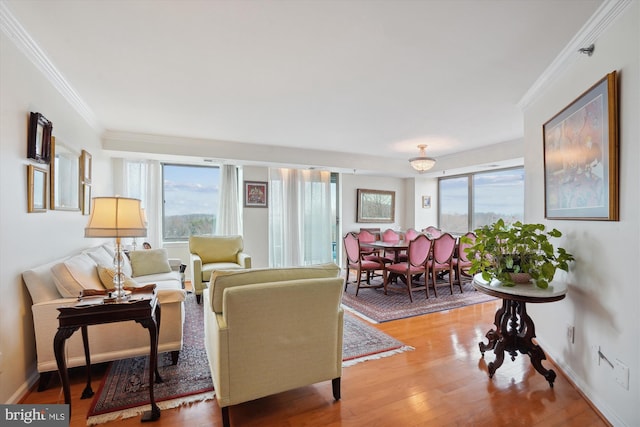 living area with ornamental molding, a wealth of natural light, and wood finished floors