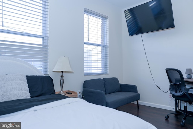 bedroom featuring dark wood-style floors and baseboards