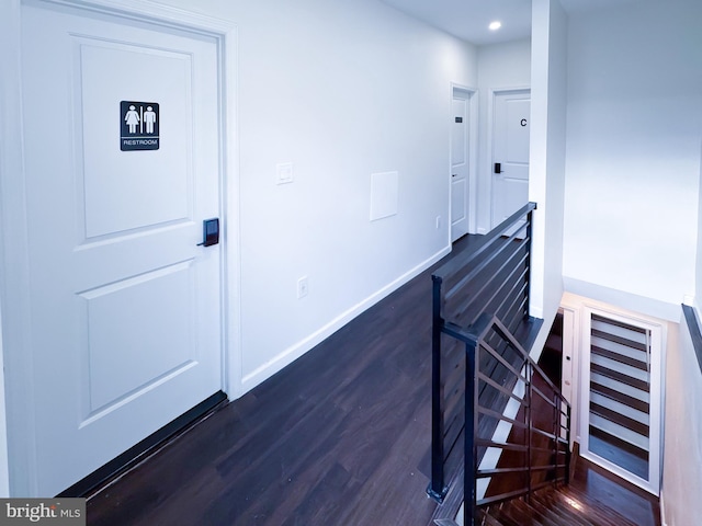 stairs featuring baseboards, wood finished floors, and recessed lighting