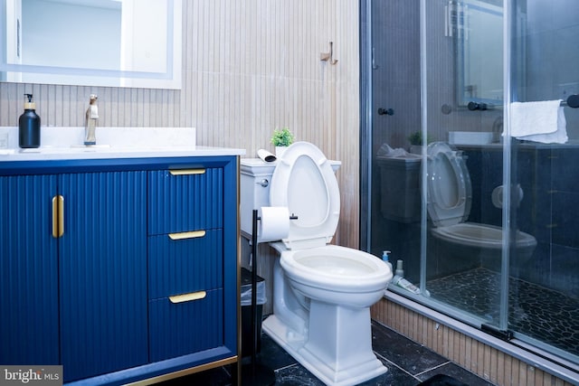 full bath featuring vanity, toilet, and a shower stall